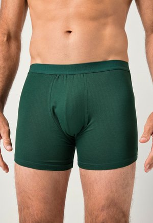 Tmavě zelené boxerky vyrobené z měkké, elastické tkaniny. Mají přiléhavý střih a podpůrnou kapsu. Pás je elastický s logem.