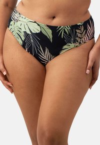 Hochgeschnittene Bikinihose auf einem dunklen Hintergrund mit einem tropischen Blattmuster in Grün und Pink. Glatte Textur und figurschmeichelndes Design.