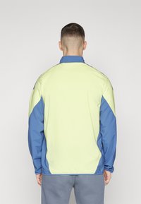 adidas Performance AJAX AMSTERDAM PRESENTATION JACKET - Træningsjakke - pulse yellow