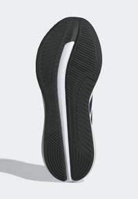 Semelle de chaussure avec une bande de roulement noire présentant une bande centrale blanche et un motif de grip texturé pour la course ou les activités sportives.