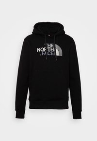 Sweat à capuche noir avec poche kangourou devant et logo "The North Face" blanc et gris sur la poitrine.