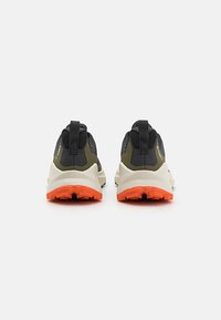 Men's outdoor sneakers with a black and olive upper, white midsole, and a textured orange outsole. Features include pull tabs for easy wear.