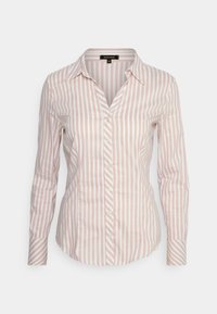 Camicia con bottoni e maniche lunghe, caratterizzata da righe verticali rosa e bianche, colletto a punta e orlo leggermente curvo. Tessuto in cotone.
