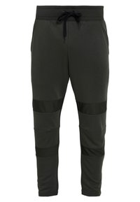 Dark green sweatpants made of soft fabric with black accent panels and an adjustable drawstring waistband. Features a tapered design.