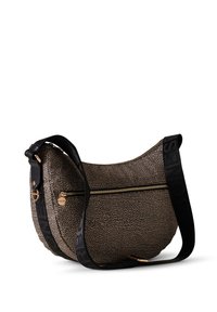 Hobo-style bag with a textured beige surface, gold zipper, and a black fabric strap featuring embossed branding. Smooth, rounded shape.