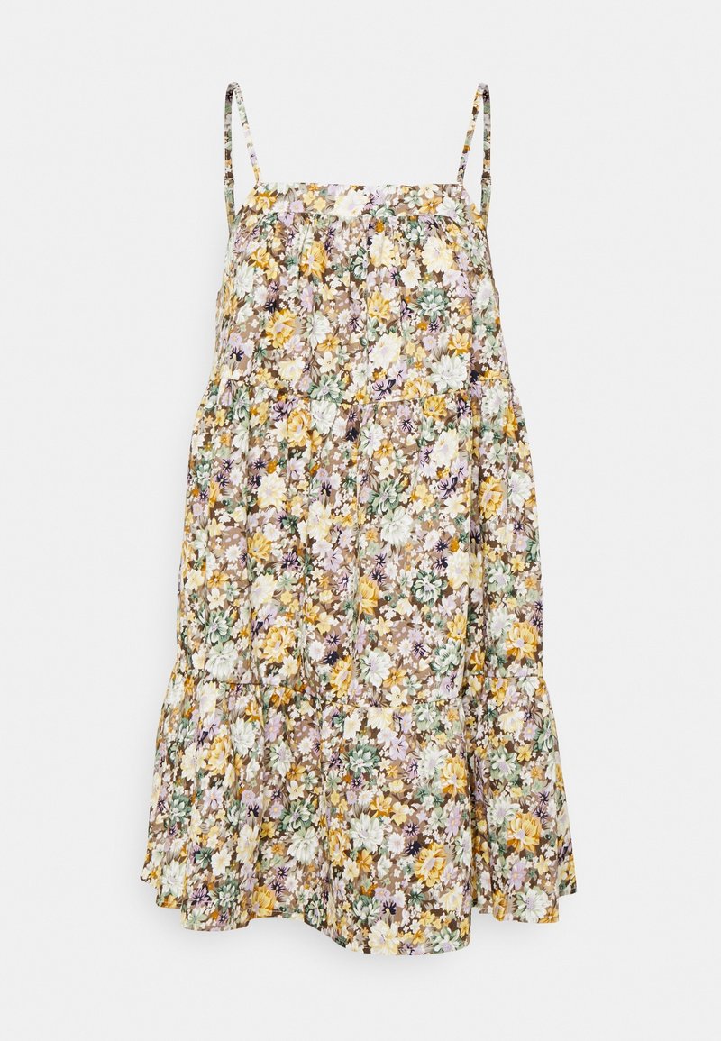 Robe sans manches mi-longue avec bretelles fines ajustables, présentant un motif floral jaune, blanc et vert sur un fond brun clair.
