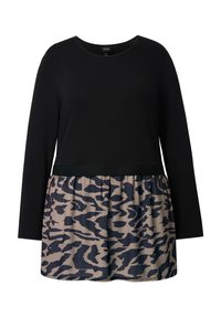 Top negro de manga larga con la parte inferior recogida, que presenta una tela beige con un estampado de animales azul marino. Textura suave en todo el top.