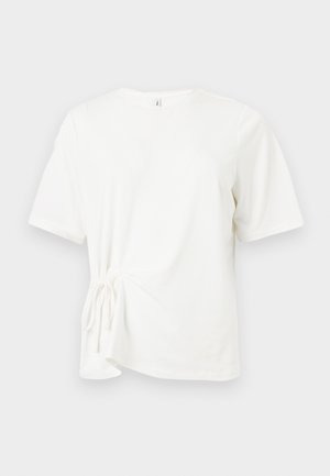 Άσπρο βαμβακερό t-shirt με κοντά μανίκια, στρογγυλή λαιμόκοψη και λεπτομέρεια με δέσιμο κόμπο στην αριστερή πλευρά. Λείο ύφασμα και κανονική εφαρμογή.