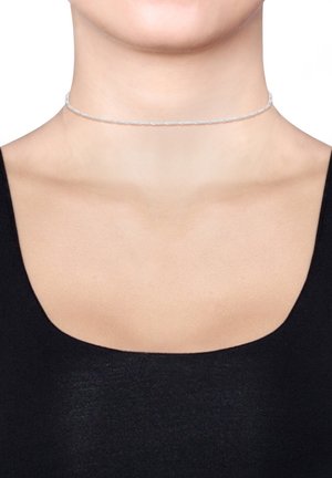 Silberne Choker-Halskette mit verdrehtem Design, dünnem Profil und glatter Textur, getragen um den Hals einer Person über einem schwarzen Oberteil.