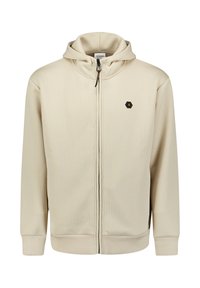 Beige rits hoodie met ribbelstructuur, verstelbare trekkoordkap, en hexagonaal logo acccent op de borst. Heeft zijzakken en manchetten.