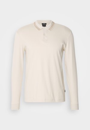 Long-sleeve polo shirt in light cream with a ribbed collar and placket. Made from soft fabric, featuring a straight hem and cuffs.