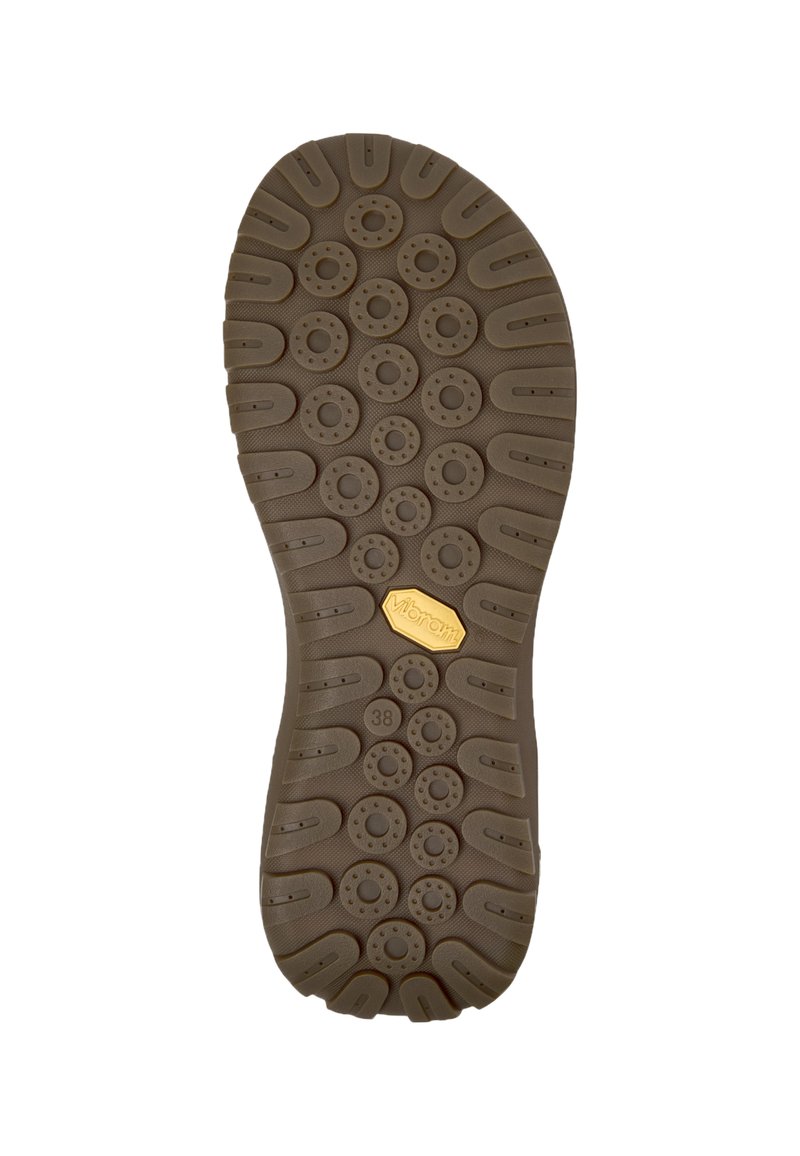 Sola di scarpa in gomma marrone con motivi di battistrada circolari e ovali. Presenta un logo dorato "Vibram" vicino al tallone. Taglia indicata come 38.