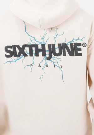 Cream hoodie featuring a graphic print with "SIXTH JUNE" in bold black letters and blue lightning-like design on the back.