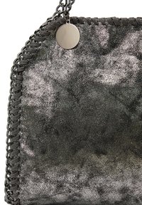 Metallic gray handbag featuring a textured surface, woven edge detailing, and a circular metal accent attached to a chain strap.