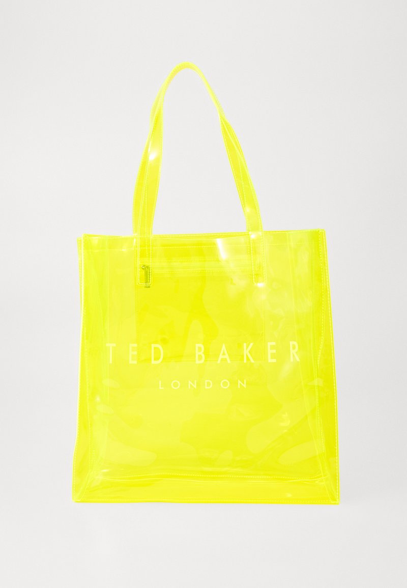 Durchsichtige Plastiktasche in leuchtendem Gelb mit zwei Tragriemen und eingeprägtem 'TED BAKER LONDON'-Logo in der Mitte. Glatte Textur.