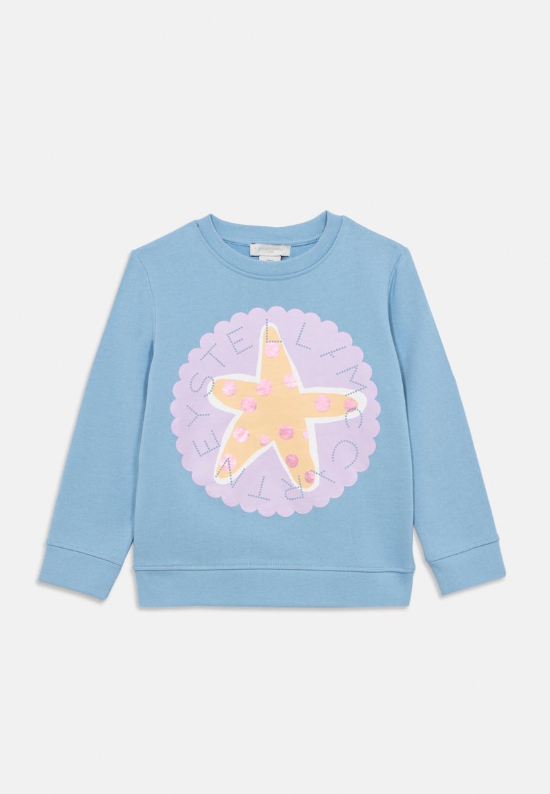 Φωτεινό γαλάζιο φούτερ από μαλακό ύφασμα με μεγάλο γραφικό αστερία σε κίτρινο χρώμα με ροζ λεπτομέρειες, περιβαλλόμενο από ροζ διακοσμητικό περίγραμμα με κυματιστό σχήμα.