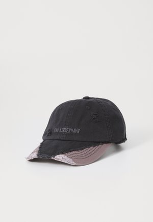 Black baseball cap with frayed edges, contrasting pink underside of the brim, and subtle brand embroidery on the front.