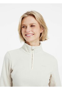 Pullover in pile di colore beige chiaro con colletto alto, chiusura a zip quarti e discreto logo sul petto. Texture morbida con vestibilità casual.