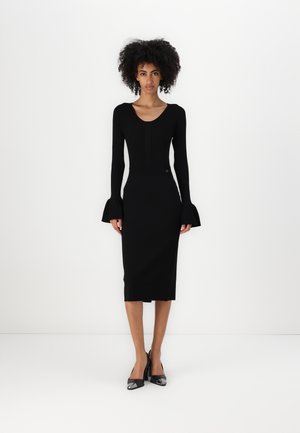 Black fitted dress with long sleeves featuring flared cuffs. Smooth texture and knee-length design, accentuated by a scoop neckline.