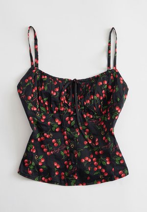 Zwart cropped topje met spaghetti bandjes, rode kersenprint en een strikdetail aan de voorkant.
