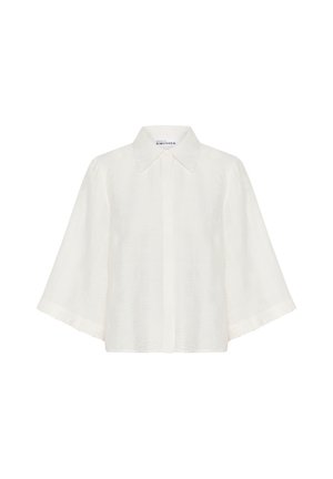 Lengvas baltas marškinėlis su tekstūruotu, susiraukšlėjusiu paviršiumi, turintis smailų apykaklę ir plačias trumpas rankoves. Uždarymas priekyje mygtukais.