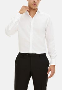 Witte overhemd met puntkraag, lange mouwen en een gladde textuur, gecombineerd met zwarte broek.