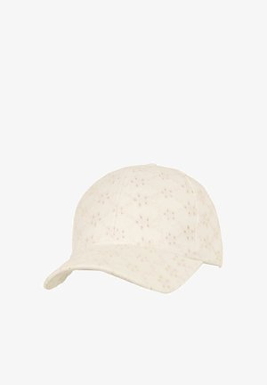 Cream-colored baseball cap with small speckled pattern and curved brim, shown against a white background.
