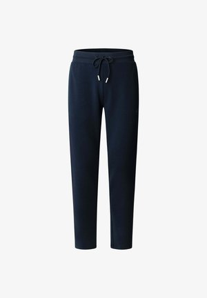 Marineblauwe joggingbroek van zacht materiaal, met een elastische tailleband met trekkoord, taps toelopende pijpen en subtiele branding aan de zijkant.