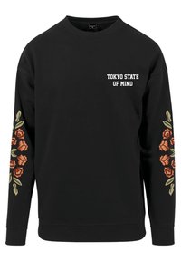 Felpa nera con la scritta "TOKYO STATE OF MIND" in bianco sul petto e disegni di fiori arancioni con foglie verdi sulle maniche.