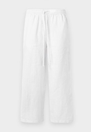 Pantalon blanc en lin à jambes larges avec ceinture élastique et cordon de serrage à l'avant, présenté sur un fond clair uni.