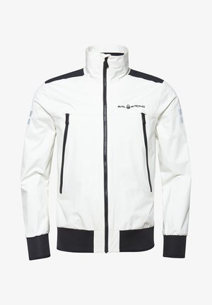 Vit vattentät jacka med svarta detaljer, dragkedjestängning, två framfickor, ribbade ärmslut och textilstruktur. Har logotyp på bröstet.