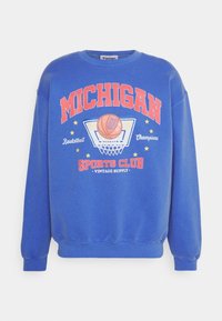 Modrá mikina s nápisem "MICHIGAN", grafikou basketbalu a hvězdami. Měkká tkanina, žebrované manžety a lem, volný střih, vintage styl.