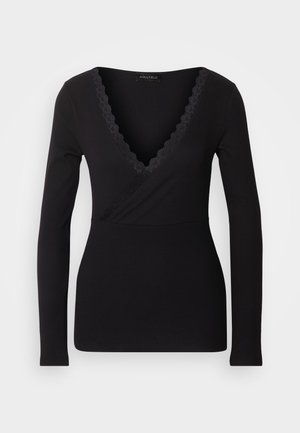 Black long-sleeve top with a V-neck, featuring a lace trim along the neckline and a fitted silhouette. Made of stretchy, soft fabric.
