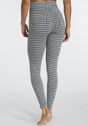 High-waisted leggings in a black and white houndstooth pattern. Made from stretchy material, featuring a smooth texture and no embellishments.