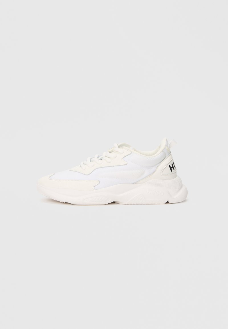 White low-top sneaker with mixed mesh and leather upper, lace-up closure, chunky sole, and black "HUGO" text on heel tab.