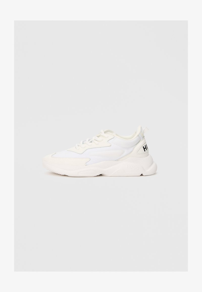 White low-top sneaker with mixed mesh and leather upper, lace-up closure, chunky sole, and black "HUGO" text on heel tab.