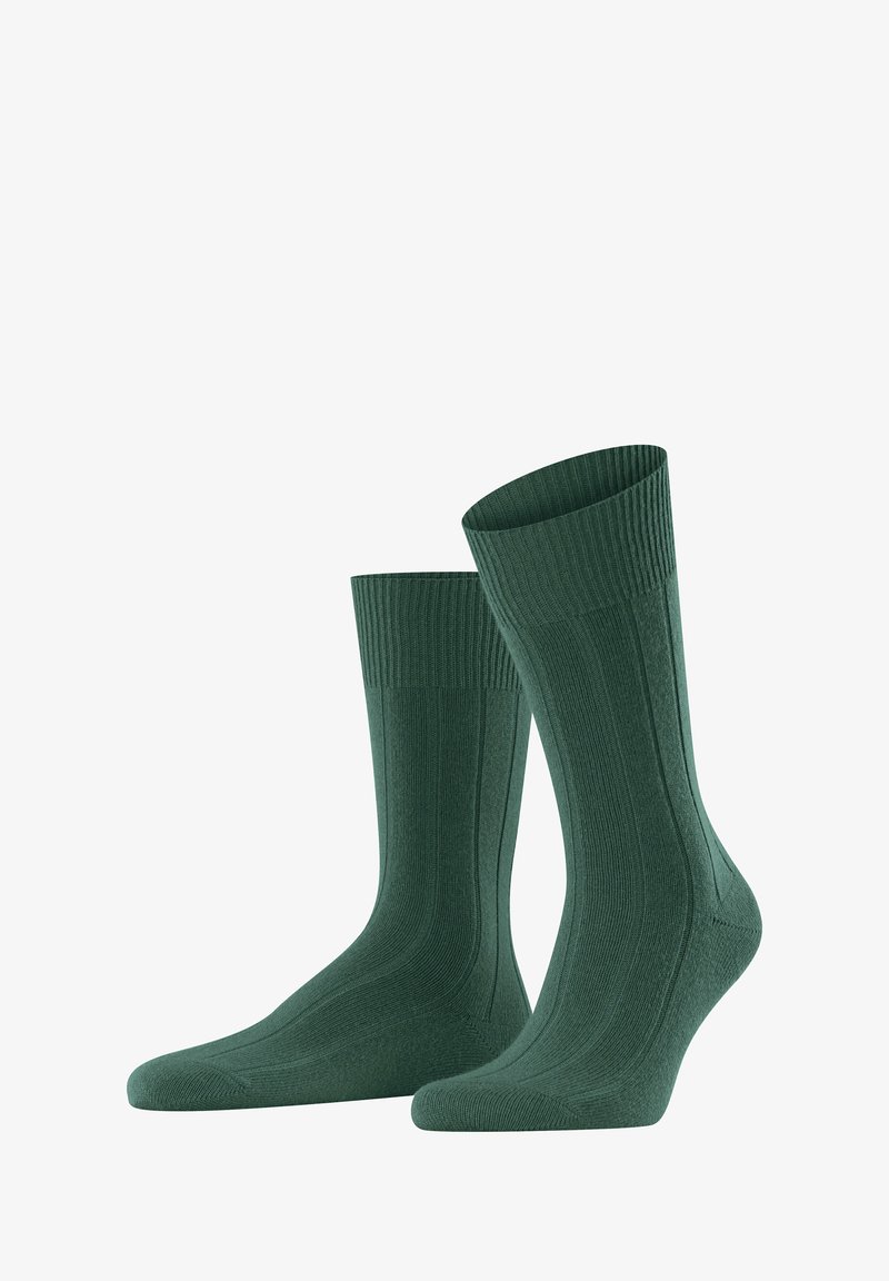 Calcetas verdes con textura acanalada, talón y puntera reforzados, y un diseño hasta la mitad de la pantorrilla para mayor comodidad y durabilidad.