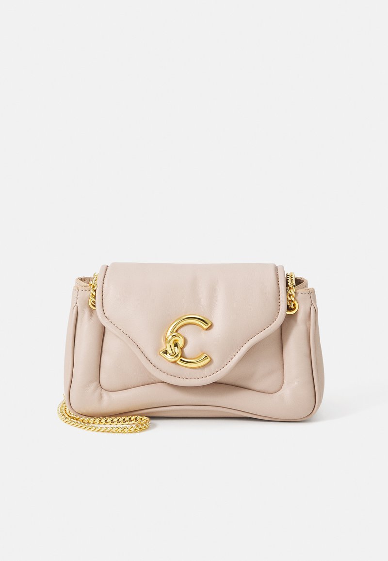 Beige leather handbag with a gold chain strap, featuring a flap closure and a prominent gold "C" logo on the front. Textured surface detail.