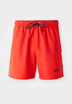 Rote Badehose aus leichtem Stoff. Elastischer Bund mit schwarzem Kordelzug. Mit kleinem schwarzem Logo am unteren rechten Bein.