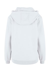 Sweat à capuche blanc avec une texture douce. Comprend une poche kangourou, des poignets et un ourlet côtelés. Design épuré sans logo ni motif visible.