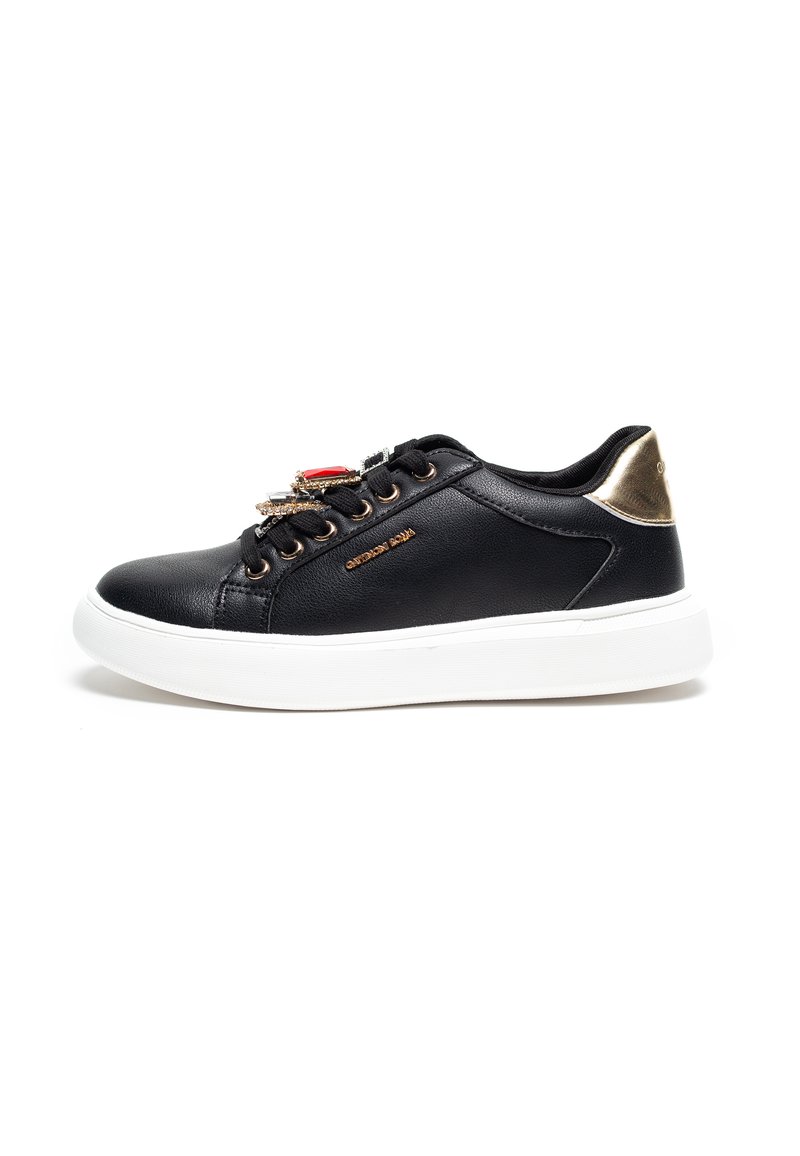 Black sneaker with leather upper, gold accents at the heel, decorative lace closure, and white rubber sole. Features brand name in gold.