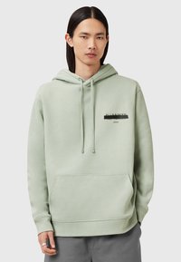 Felpa verde menta con cappuccio regolabile, tasca a marsupio e logo stampato. Tessuto morbido con polsini e orlo a coste. Vestibilità casual.