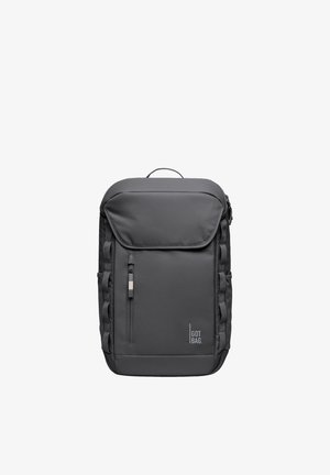 Black rectangular backpack with front zipper pocket, flap top, side loops, handle on top, and "GOT BAG." logo at bottom right.
