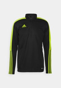 Czarny sportowy golf z półzamkiem, zdobiony neonowozielonymi akcentami na ramionach i rękawach oraz trzema pionowymi paskami na rękawach.