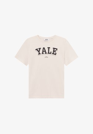 Ανοιχτό μπεζ βαμβακερό t-shirt με κοντά μανίκια και στρογγυλή λαιμόκοψη. Μαύρο έντονο κείμενο "YALE" εκτυπωμένο στο στήθος σε καμπυλωτό στυλ.
