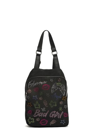 Black backpack with adjustable straps decorated with colorful stud designs of stars, lips, wings, and the words "Glamour" and "Bad Girl."