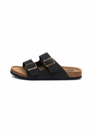 Sandalias de ante negro con dos correas ajustables y hebillas en tono dorado. La plantilla de corcho y la suela de goma texturizada ofrecen comodidad.