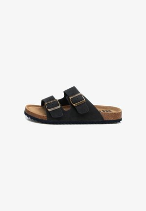 Sandalias de ante negro con dos correas ajustables y hebillas en tono dorado. La plantilla de corcho y la suela de goma texturizada ofrecen comodidad.