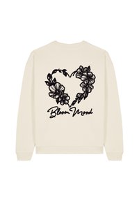 Felpa color crema con un design floreale a forma di cuore in nero, con la scritta "Bloom Mood" sotto il grafico. Tessuto morbido.