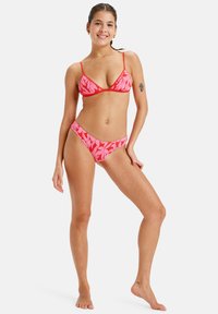 Red bikini set featuring a triangle top and matching bottom, adorned with a pink floral pattern. Made from soft, stretchable fabric.